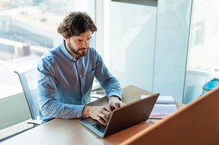 Best Supplements for Focus and Concentration in 2025. An office worker is focusing on his laptop.