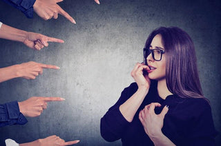 Best Nootropics for Social Anxiety. A woman feels anxious as fingers point at her.