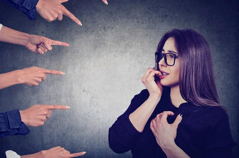 Best Nootropics for Social Anxiety. A woman feels anxious as fingers point at her.
