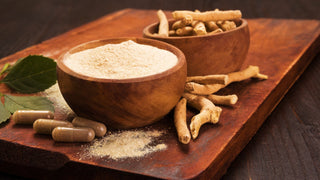 Best Adaptogens for Immune Support. Raw adaptogen root, powder and supplements on a wood table.