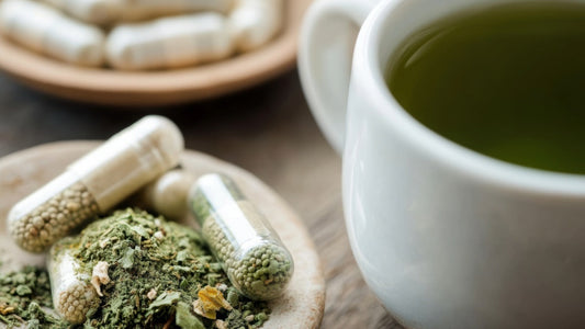 Can I Take L-Theanine and L-Tyrosine Together for Better Focus? A mug of green tea next to theanine and tyrosine capsules.