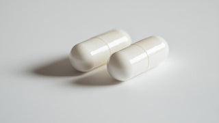Choline inositol benefits for human health. Two white capsules.