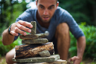 Nootropics for Concentration with a man building a rock tower